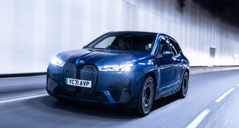 The BMW iX driving through an underground tunnel