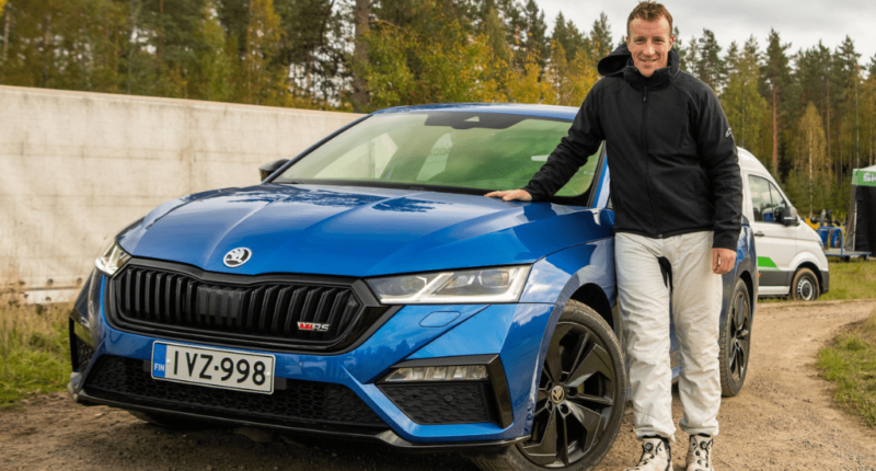 Northern Ireland rally driver pictured beside a Skoda Octavia estate in Finland
